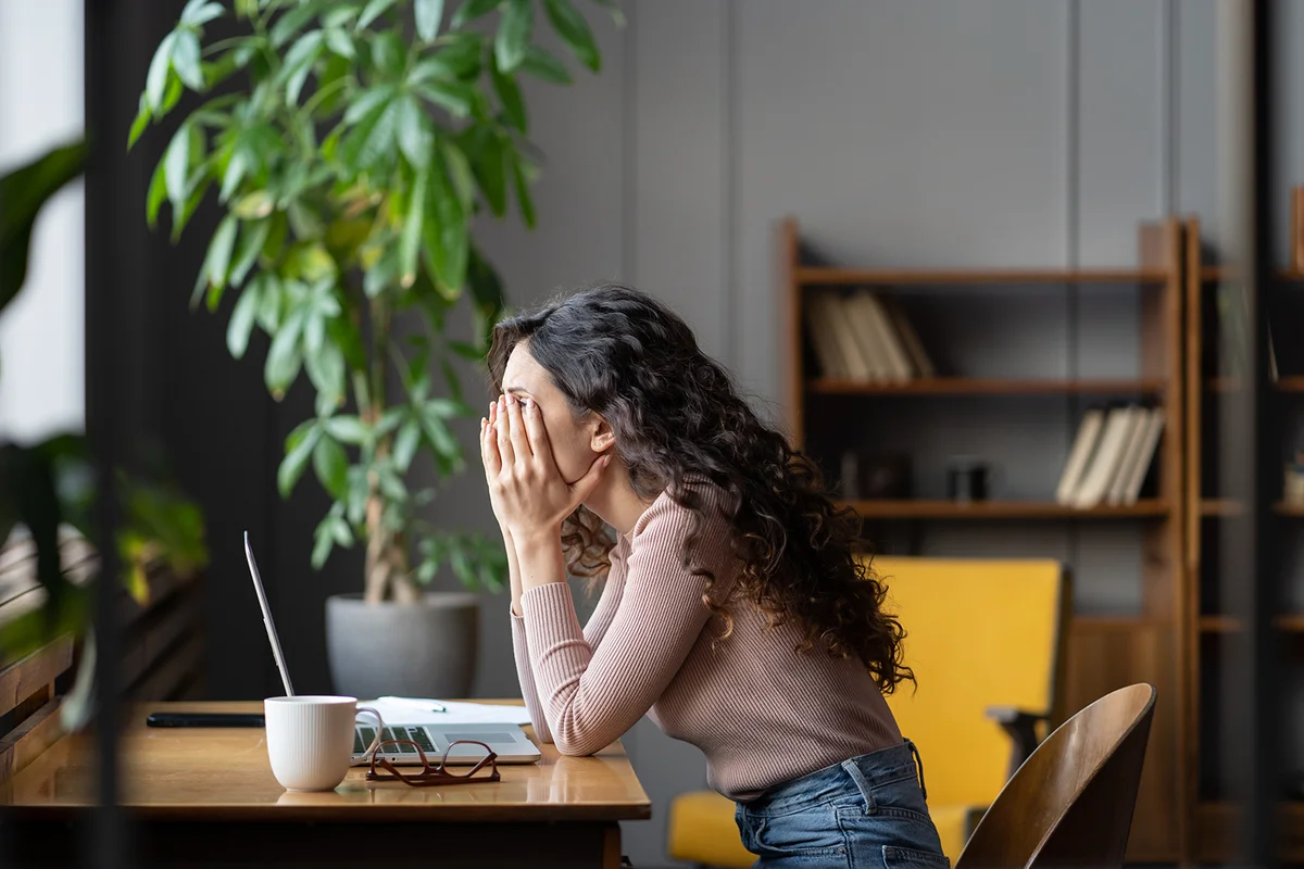 Disappointed woman office worker struggling through task