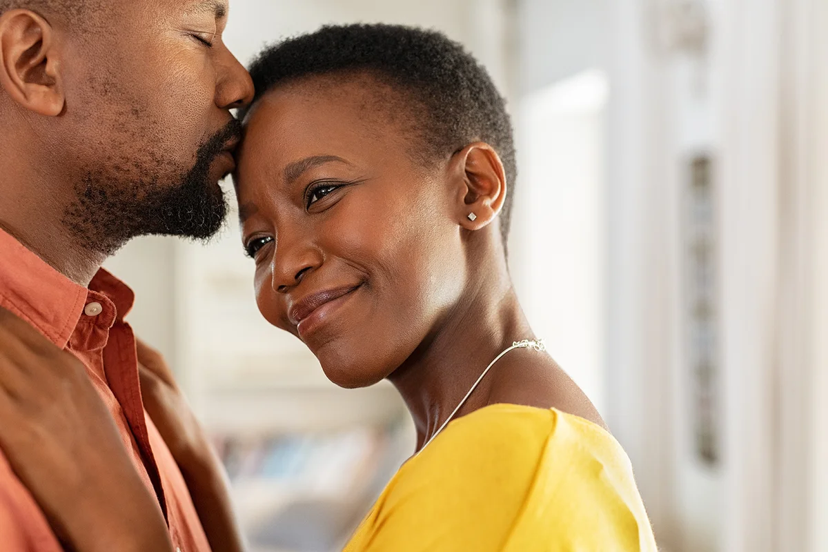 Romantic man kissing woman on forehead