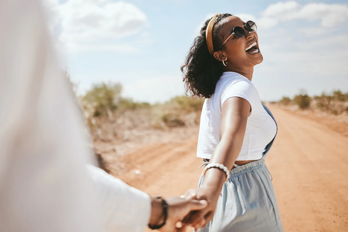 woman with a big smile walking with partner