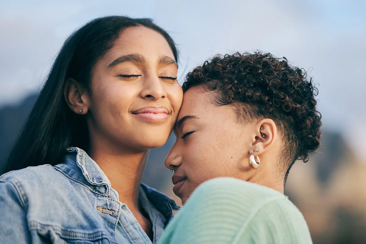 Happy, hug and queer couple with love, care and happiness with marriage
