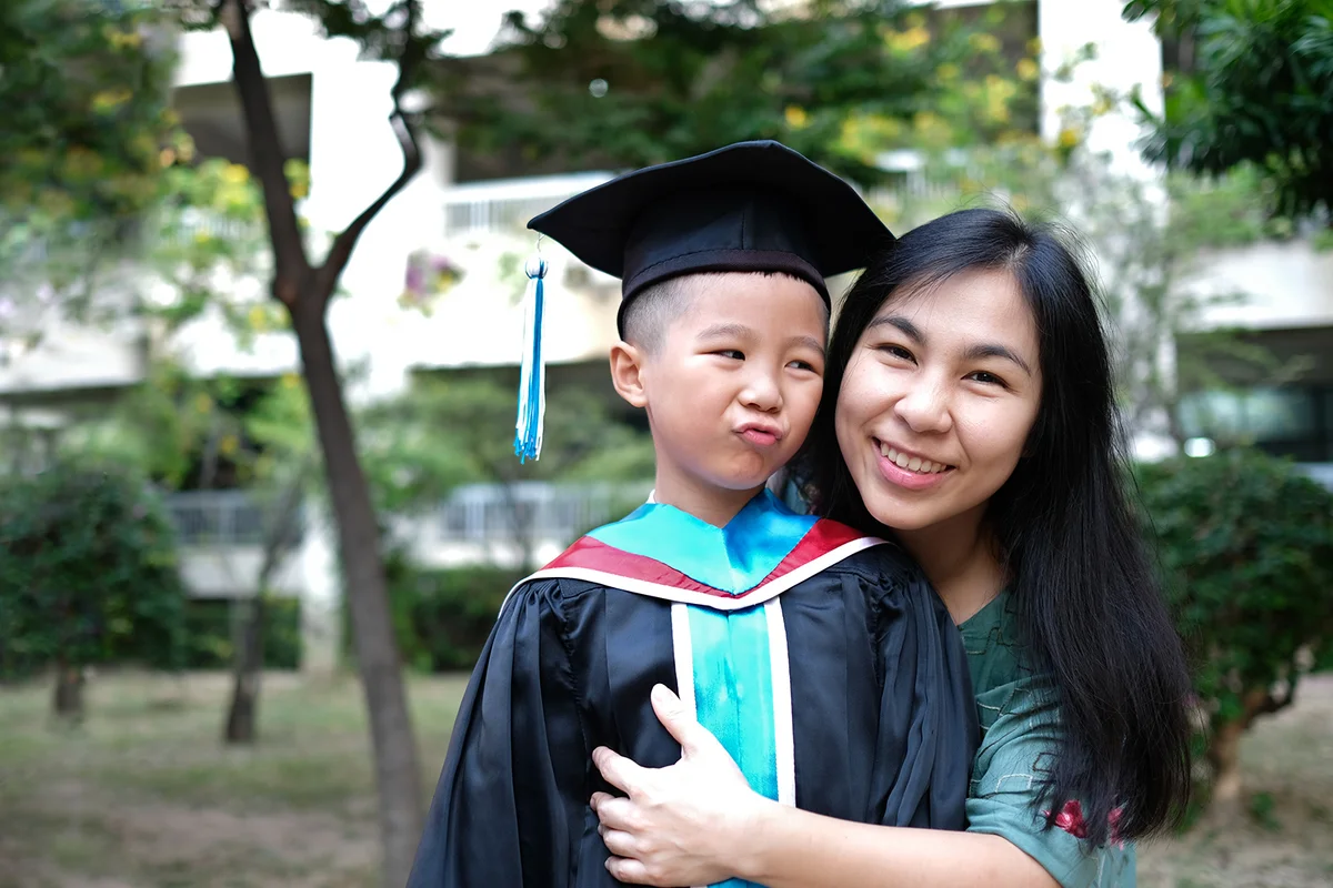 Mother congratulates her child on graduating from kindergarten