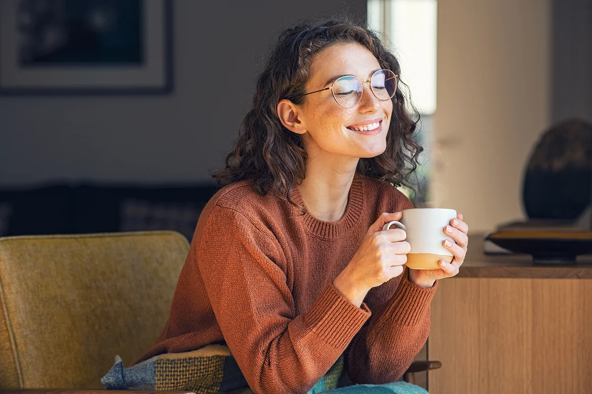 woman drinking a cup of tea in an autumn morning
