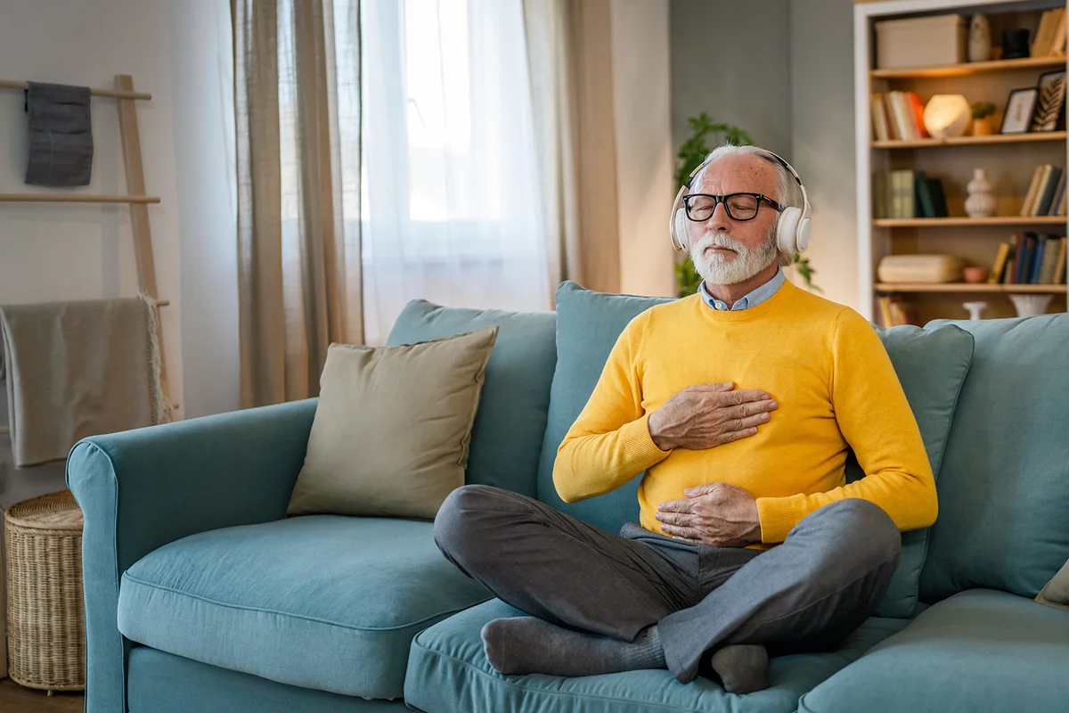 male using headphones for online guided meditation