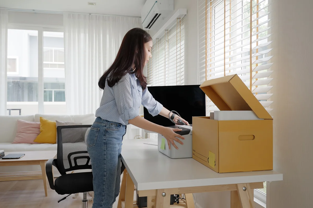 workspace set up desk picking file folder from box