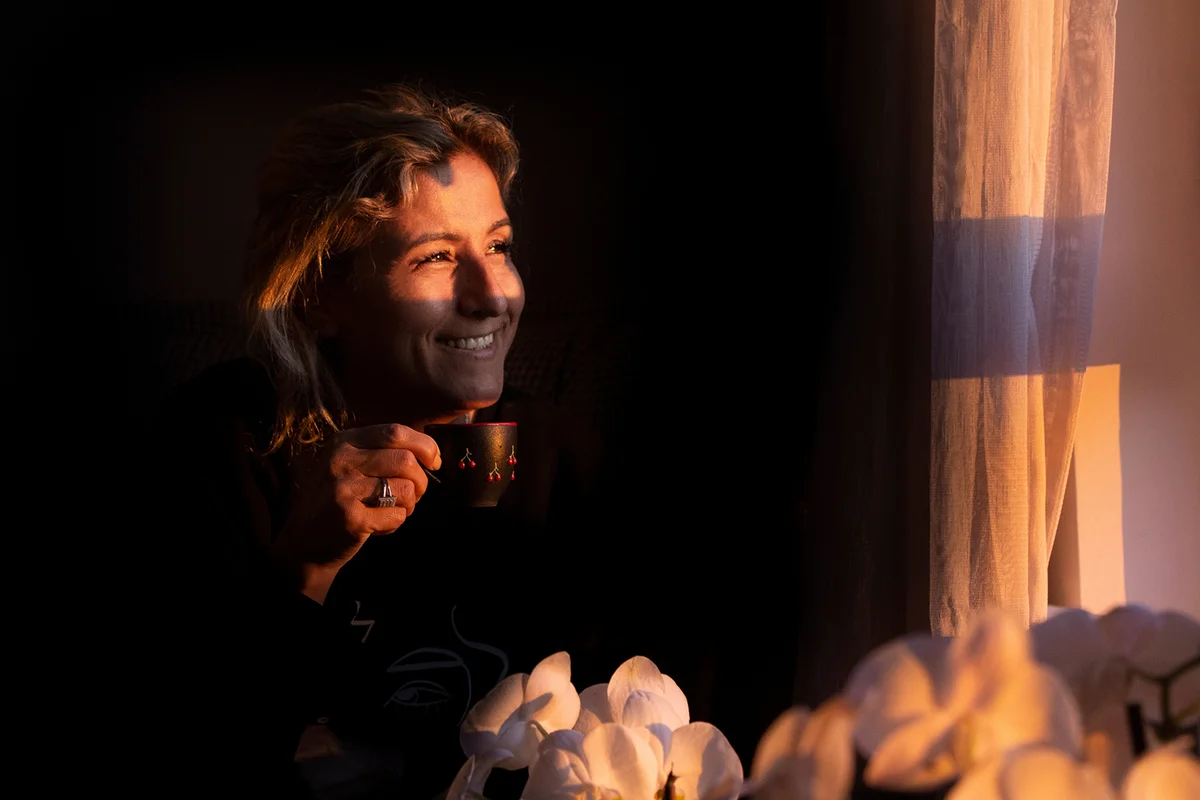 A woman is watching outside at dawn