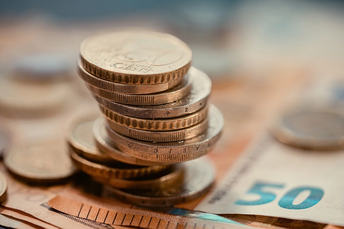 Pile of euro coins on euro notes