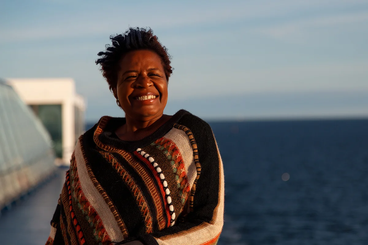 Nice portrait of an older woman looking out to the sea and cruising on a cruise ship