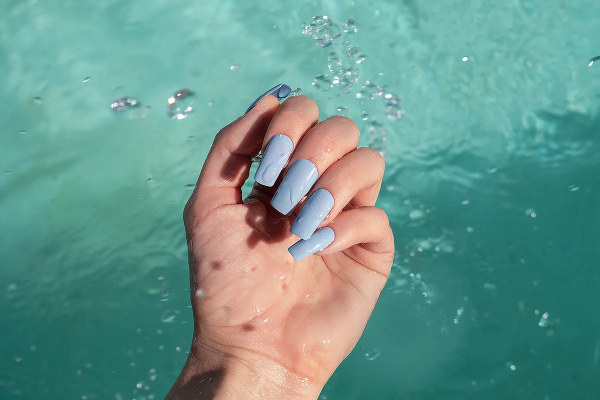 Glitter blue nail polish manicure