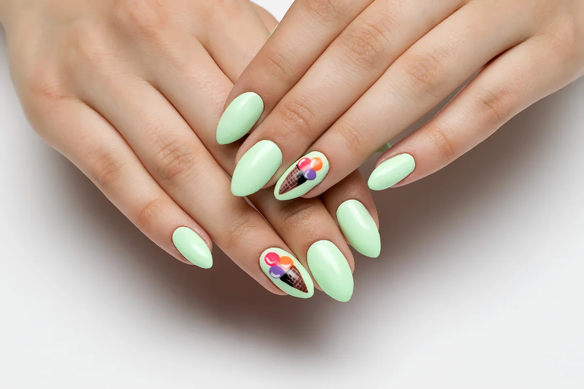 mint,light green manicure on sharp long nails with painted ice cream