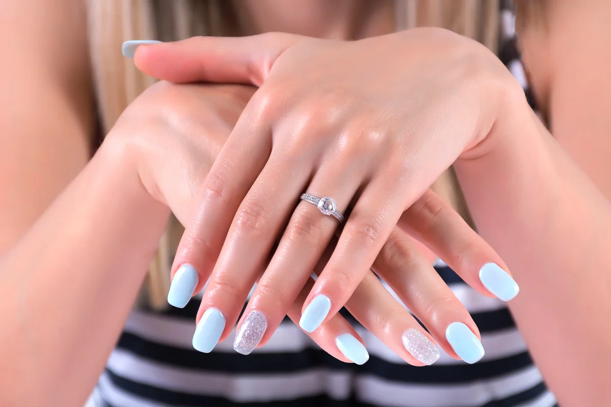 Girl hands with blue nails polish manicure