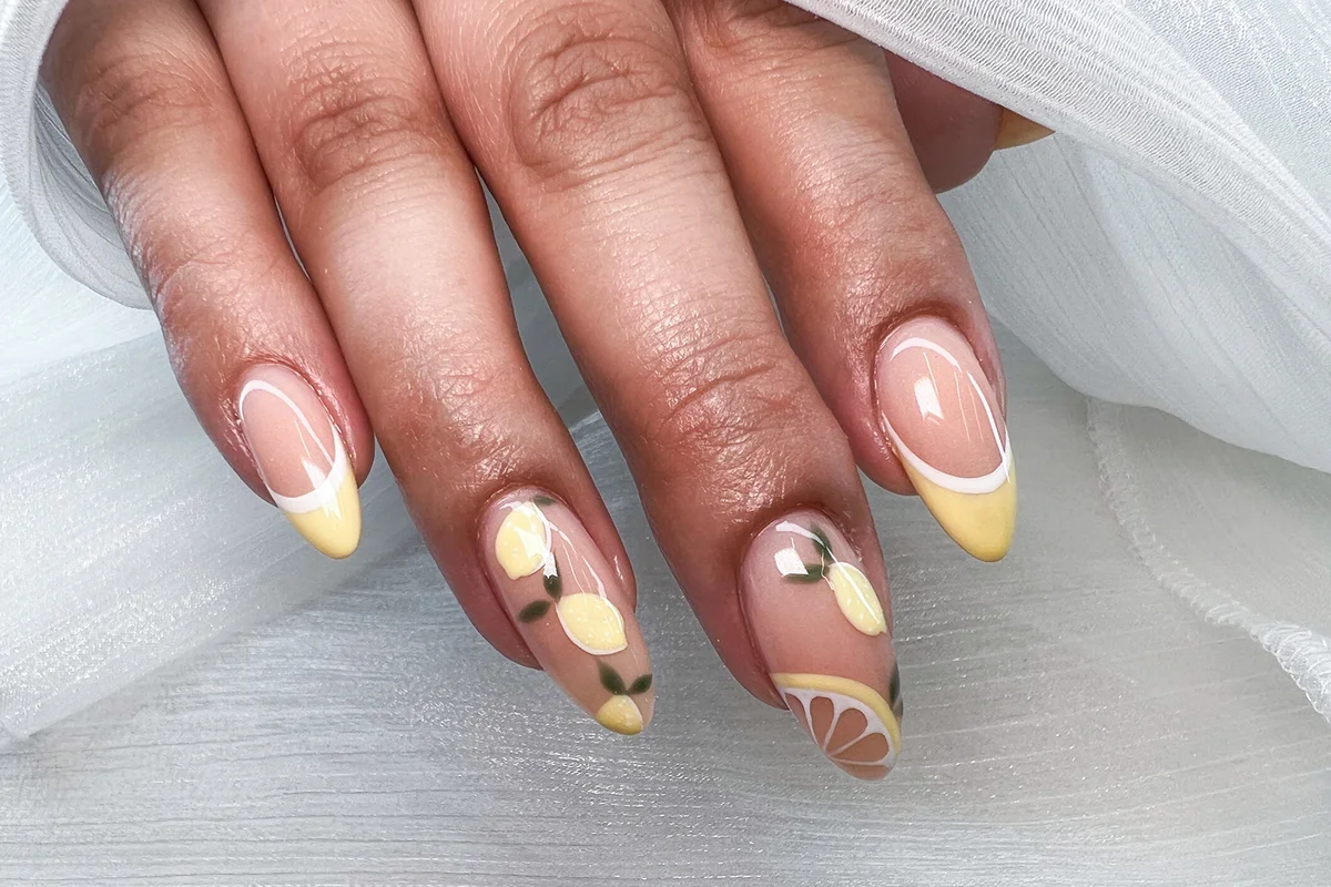 nail design stylishly drawn lemons on yellow