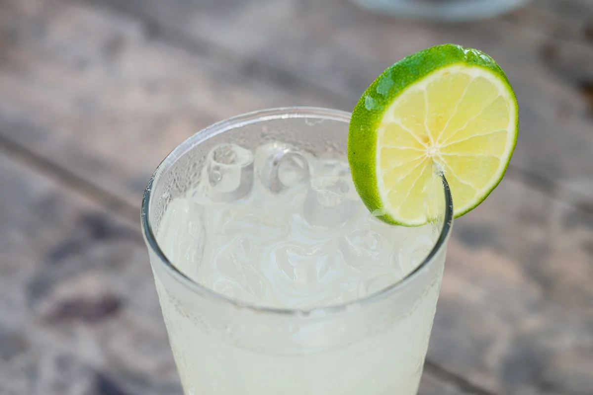 Cold fruit juice or nfused water or lemonade with lemon lime slice