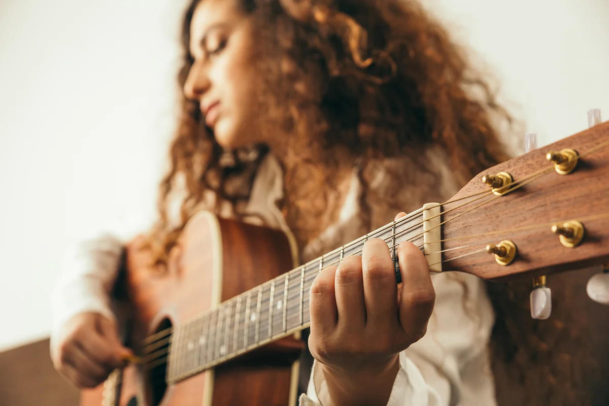 Girl playing guitar and singing