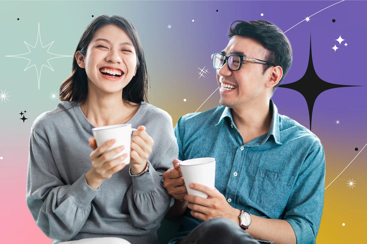 Couple laughing and drinking coffee at home