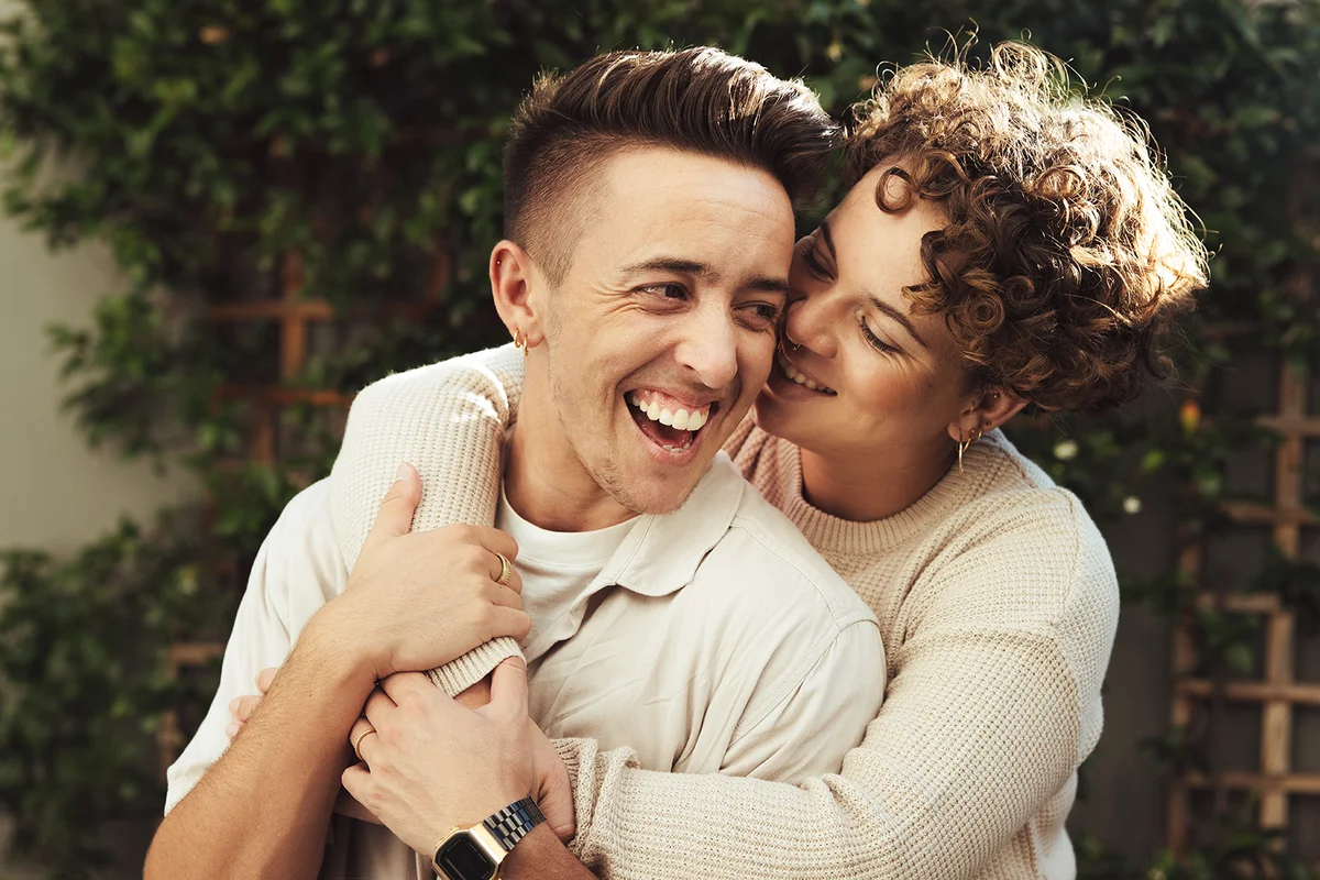 Cheerful couple embracing each other outdoors.