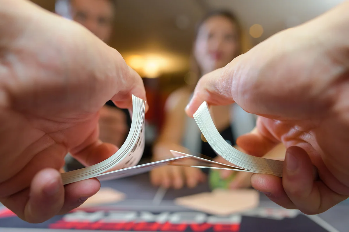a close up of a croupier dealing cards