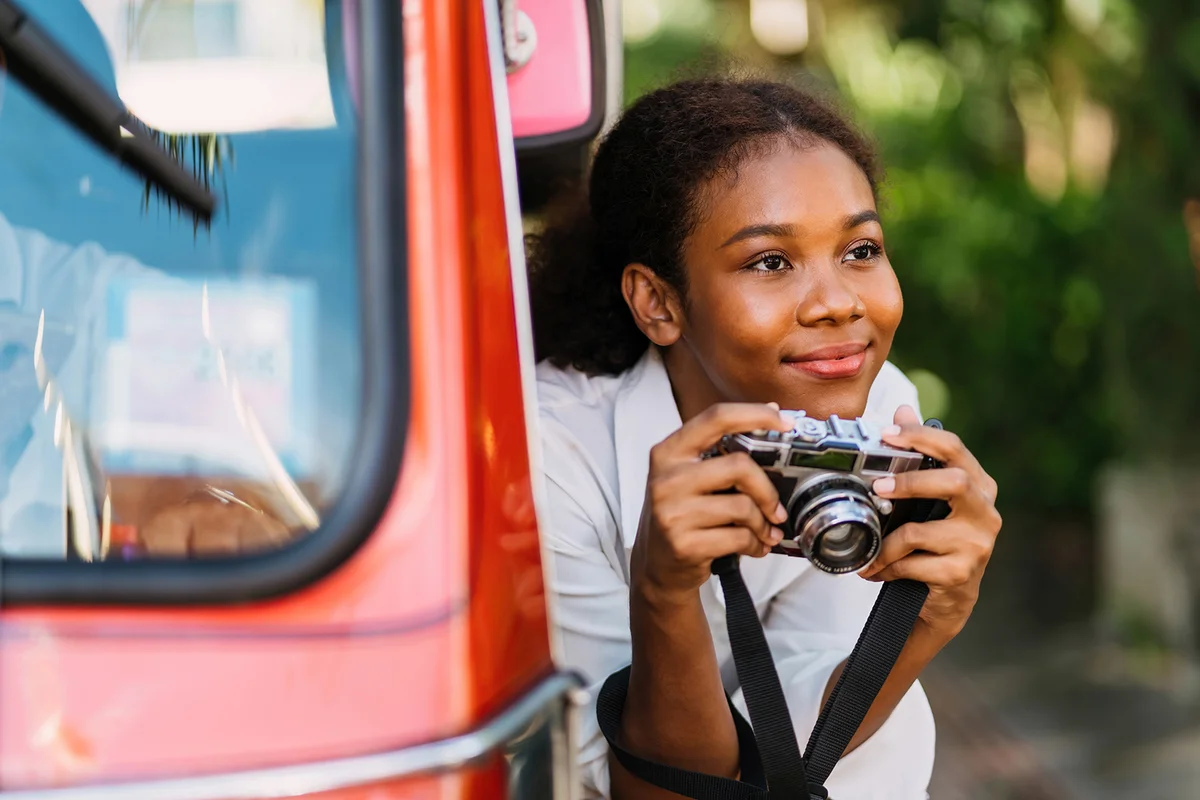 african american tourist checking vintage film for photograph.