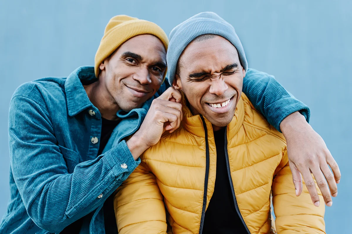 twin brothers playing with each other with love an affection,