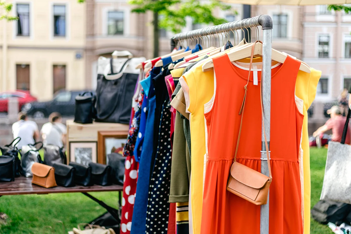 Clothes on the rail on the summer outdoor vintage fashion designer market.
