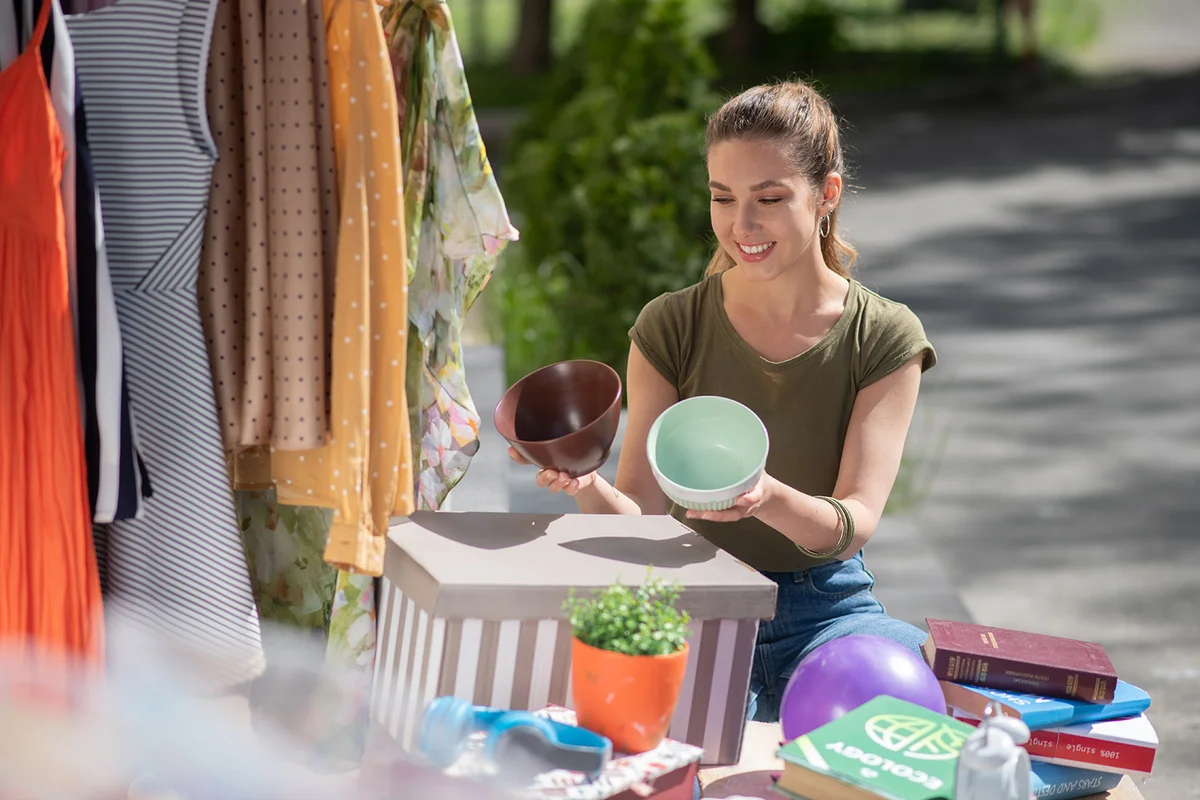 Nice long haired woman holding empty pots while deciding which one is better