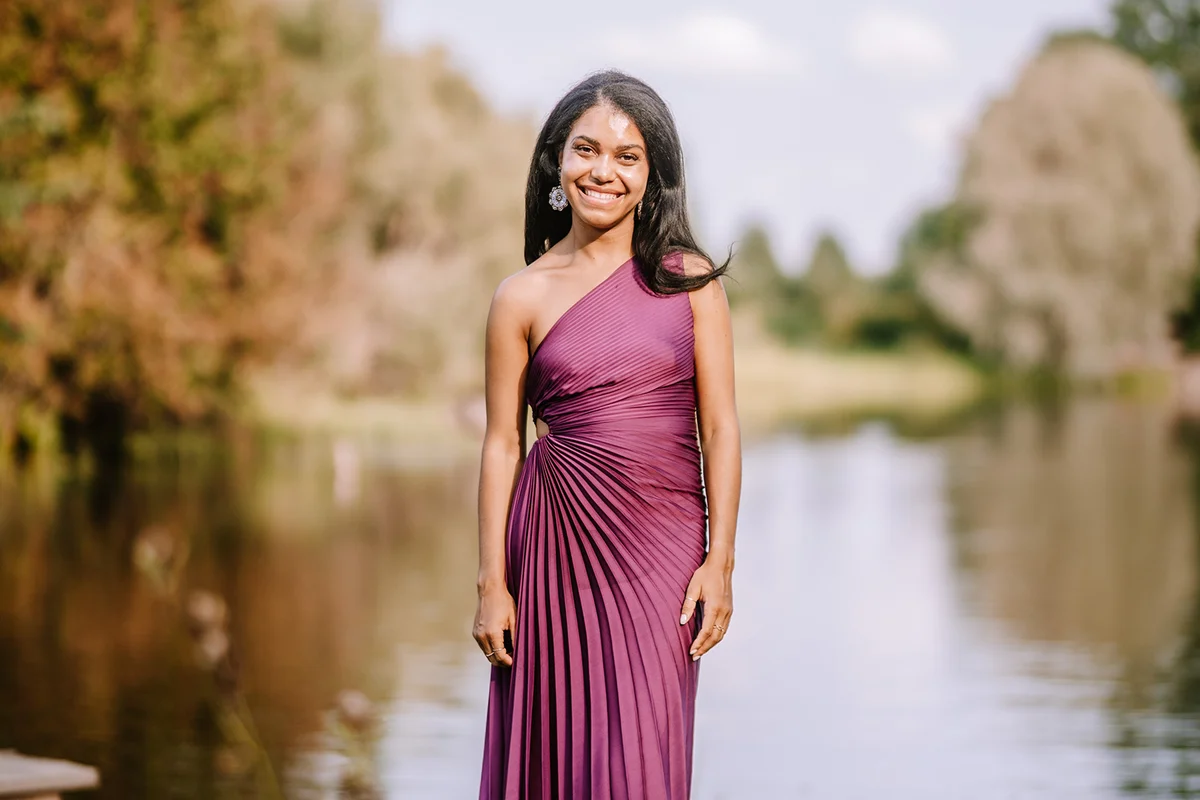 smiling woman in a one-shoulder dress
