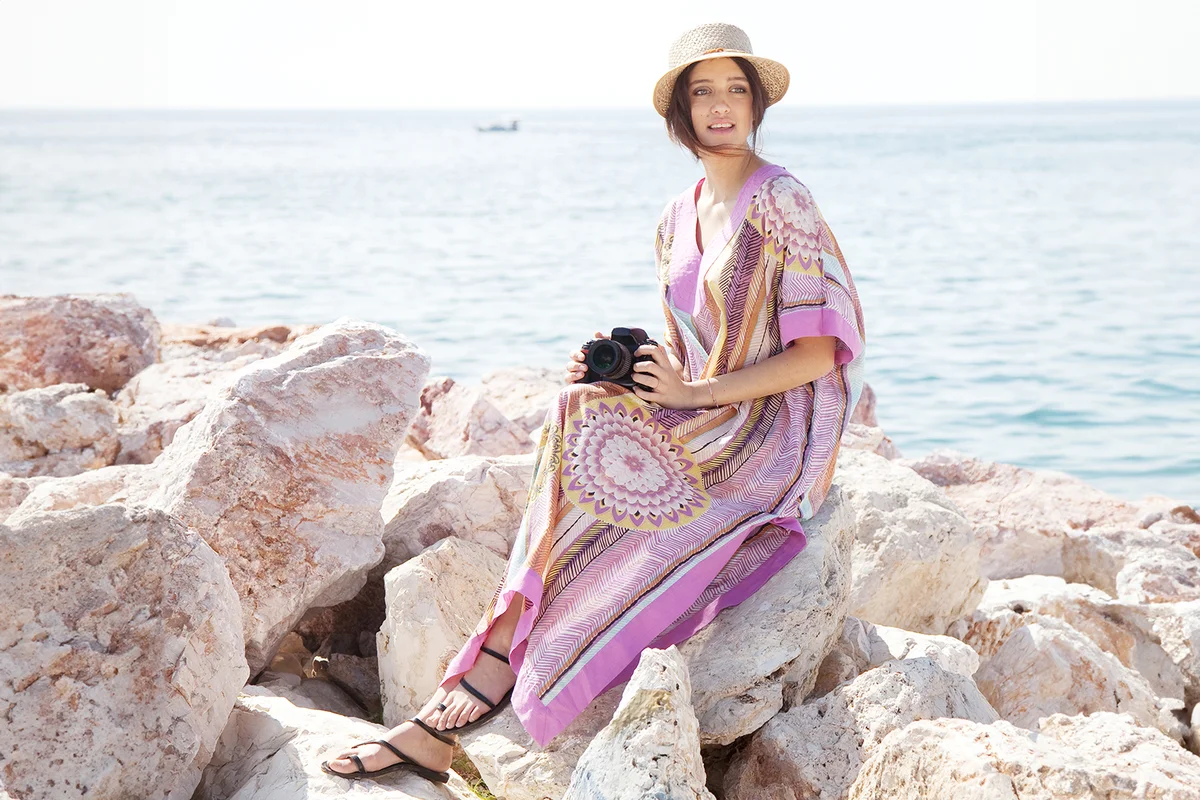 woman summer dressing sitting on the rocks