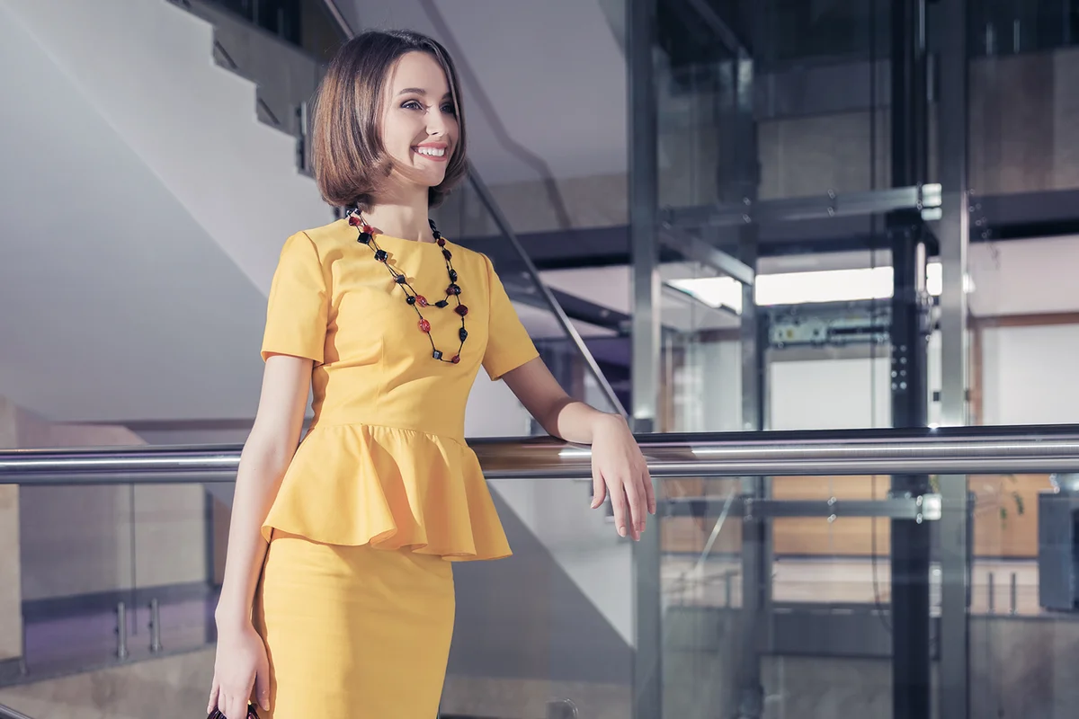 woman leaning on railing at office