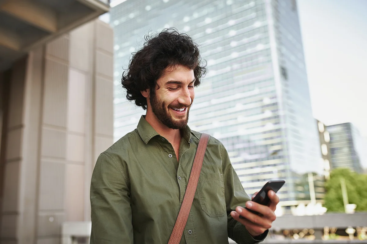 young man in formal clothing using smartphone