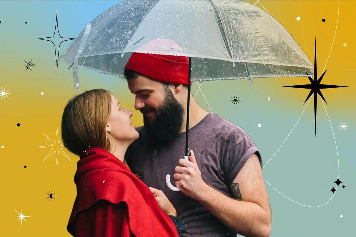 couple posing together in the rain on a city street