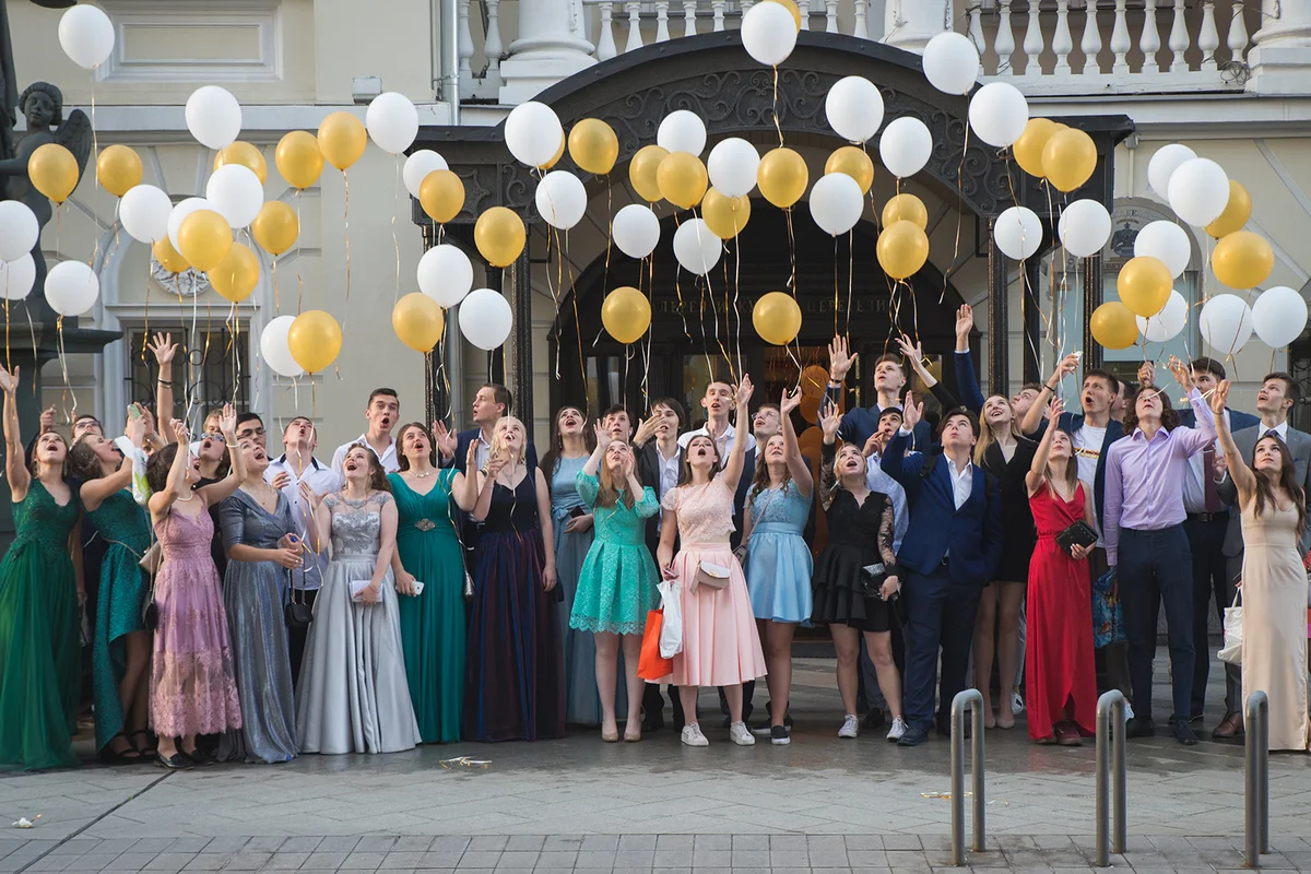 school pupils in formal dress and suit at homecoming dance