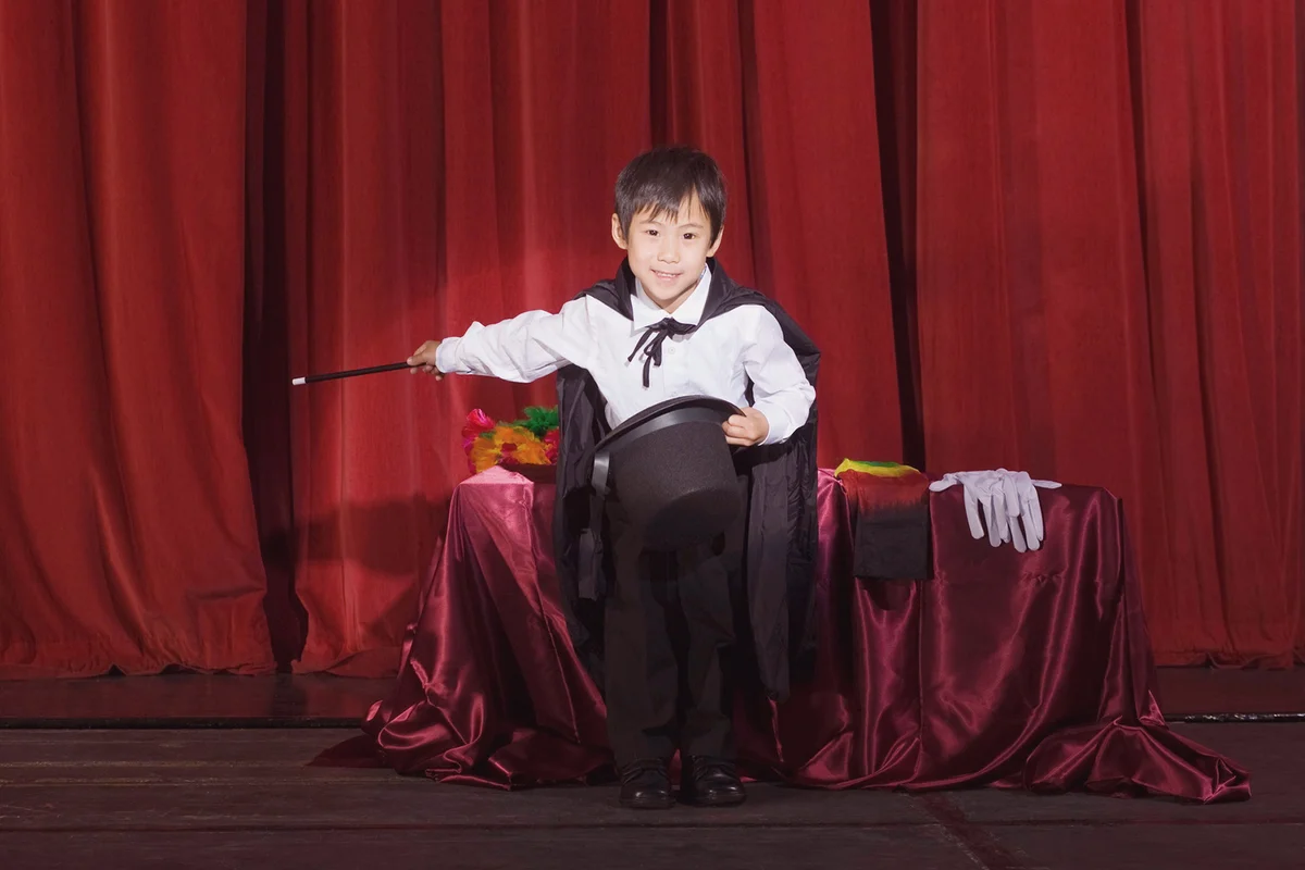 Boy doing magic trick on stage