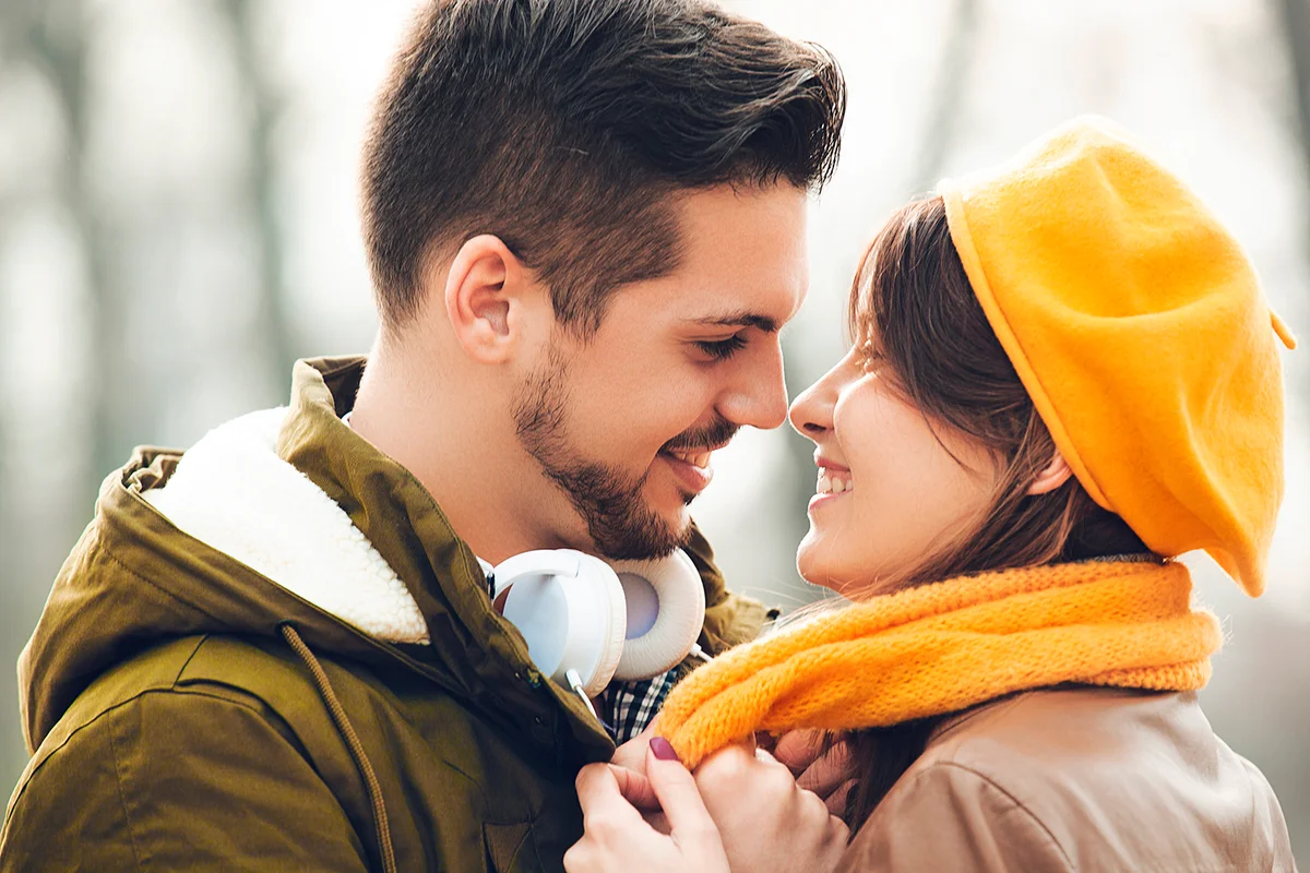 Young and attractive couple enjoying fall in the park.