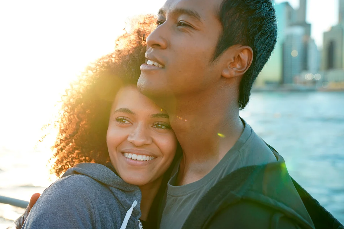 Couple enjoying scenery of Manhattan from Brooklyn Heights at sunset