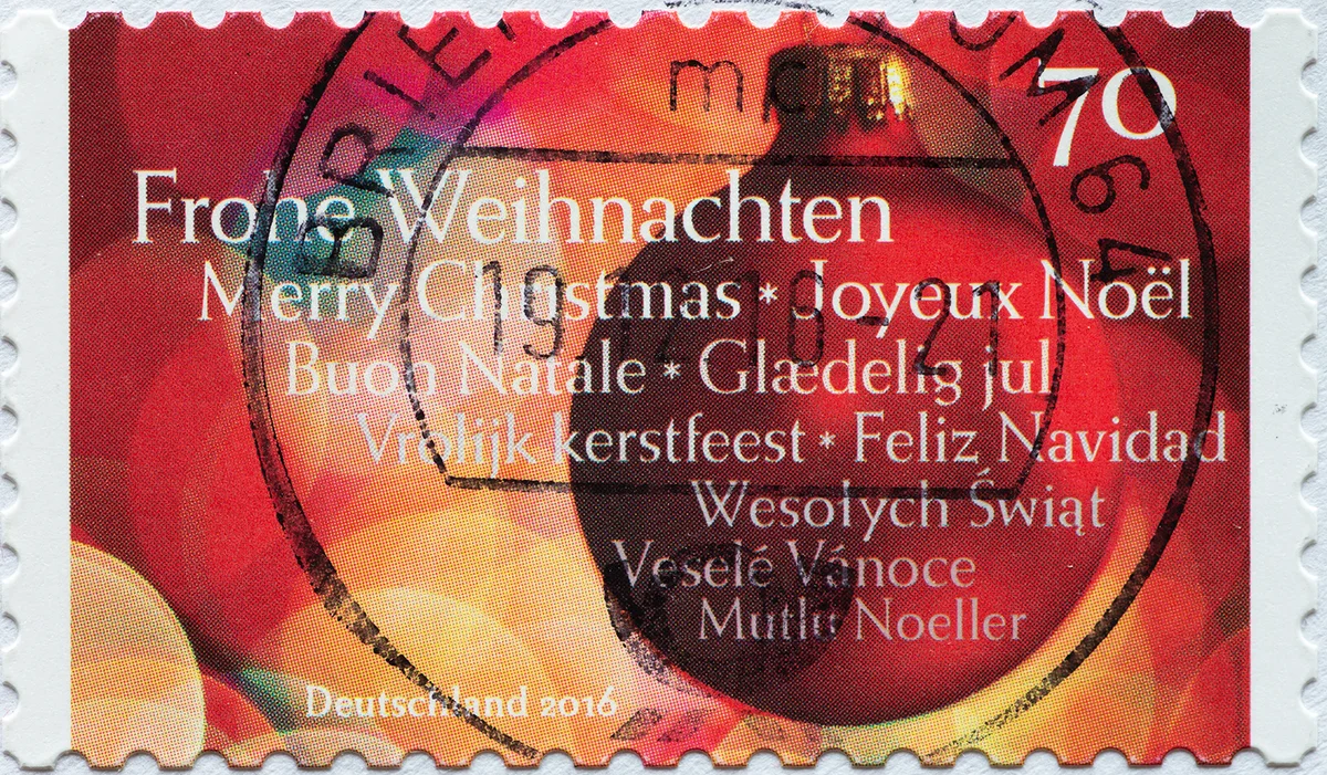 CIRCA 2016: a postage stamp printed in Germany showing a red Christmas ball and the text in several languages