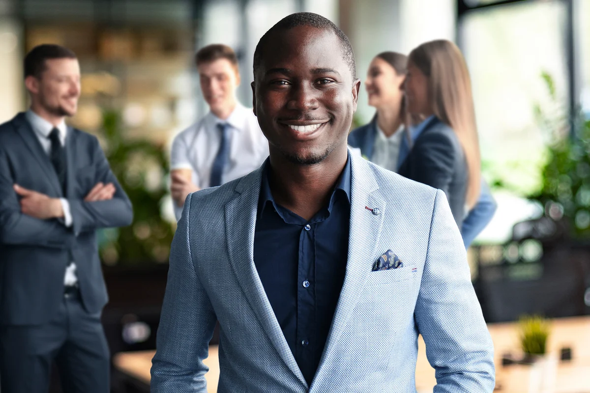 Handsome cheerful african american executive business man at the workspace office