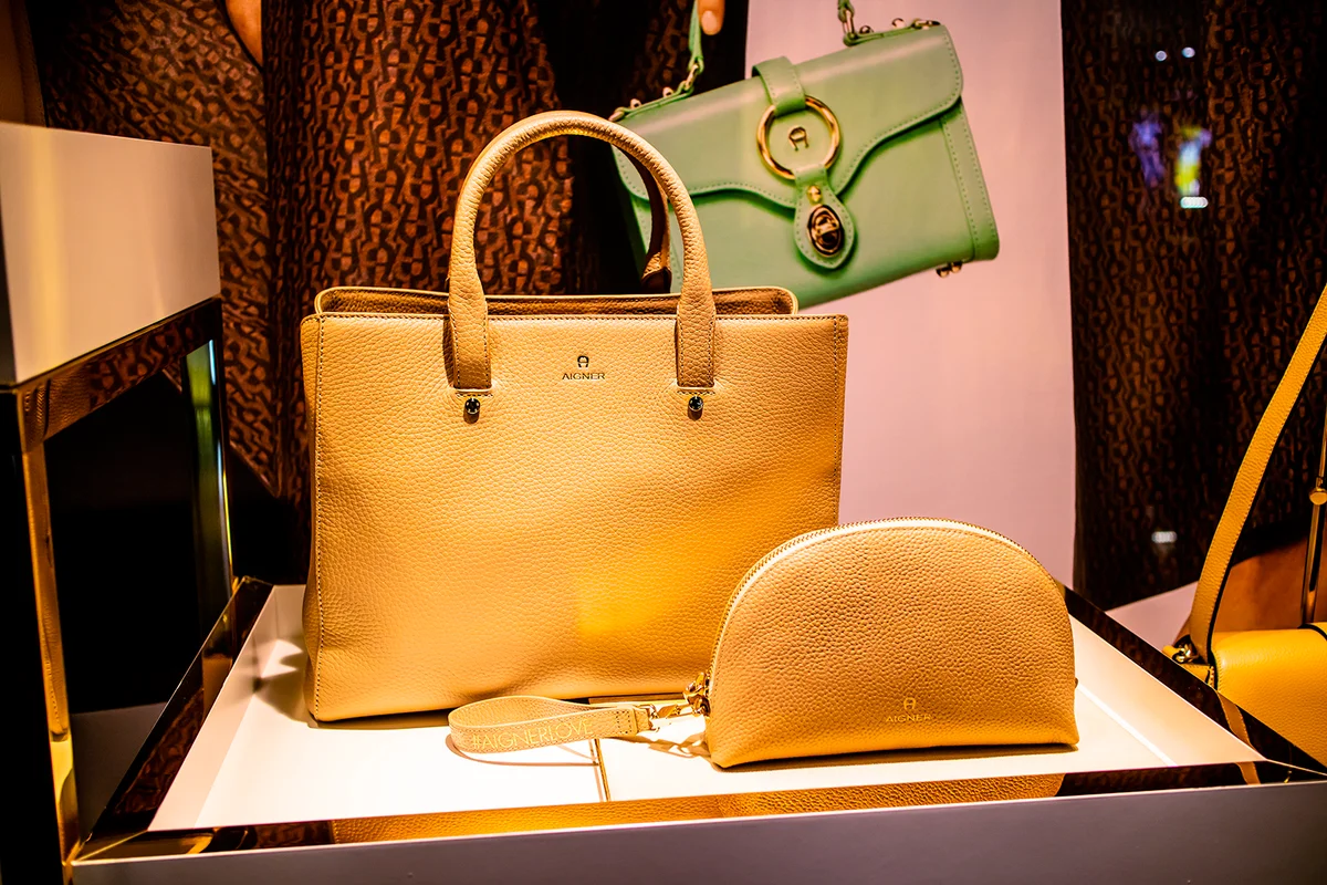 Geneva, Switzerland, March 09, 2019, Aigner handbag in fashion store, shop with modern clothes, blouses, pants, skirts, shoes, coats, jackets, jeans, shirts from Aigner fashion house