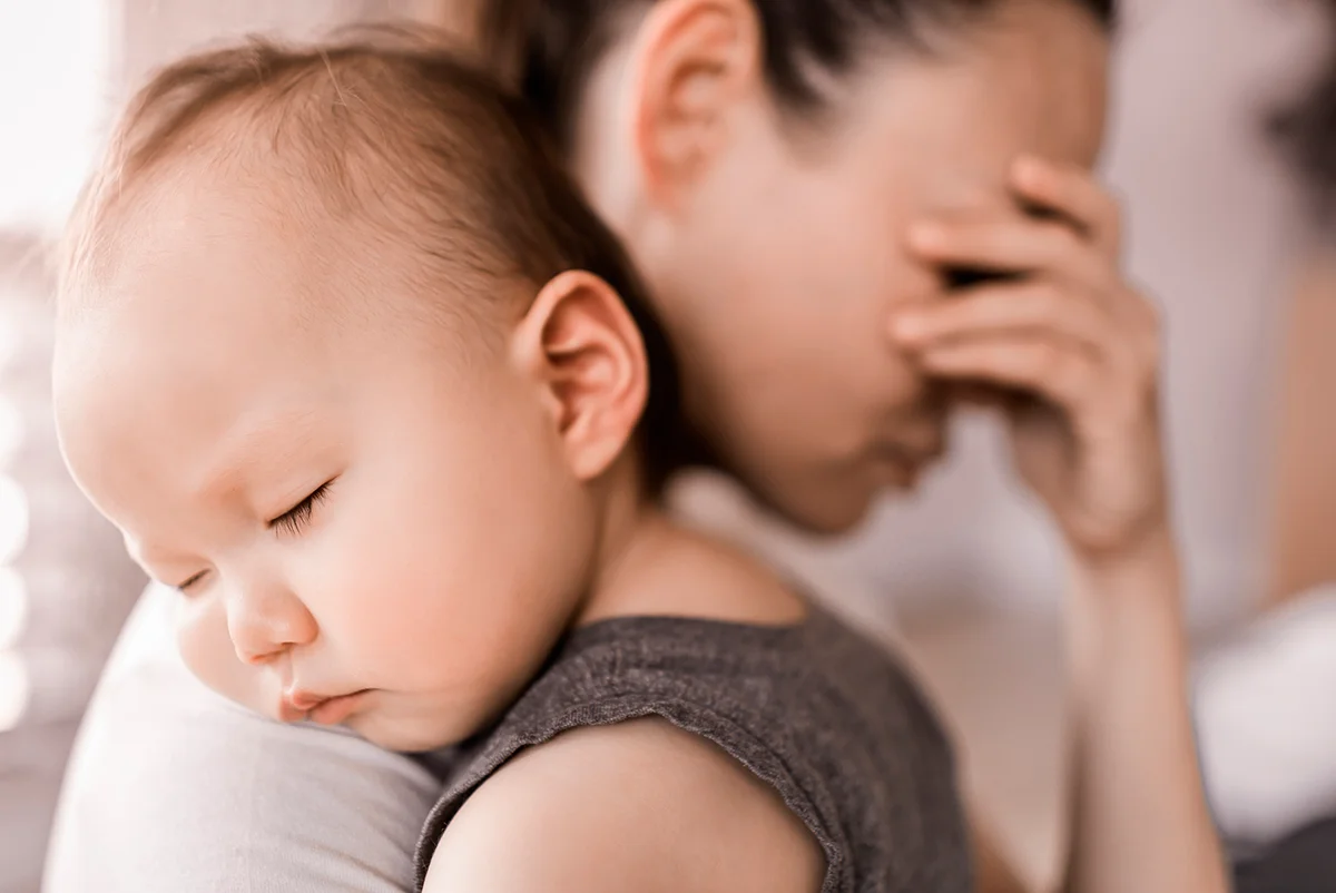 Tired exhausted mother the care of baby