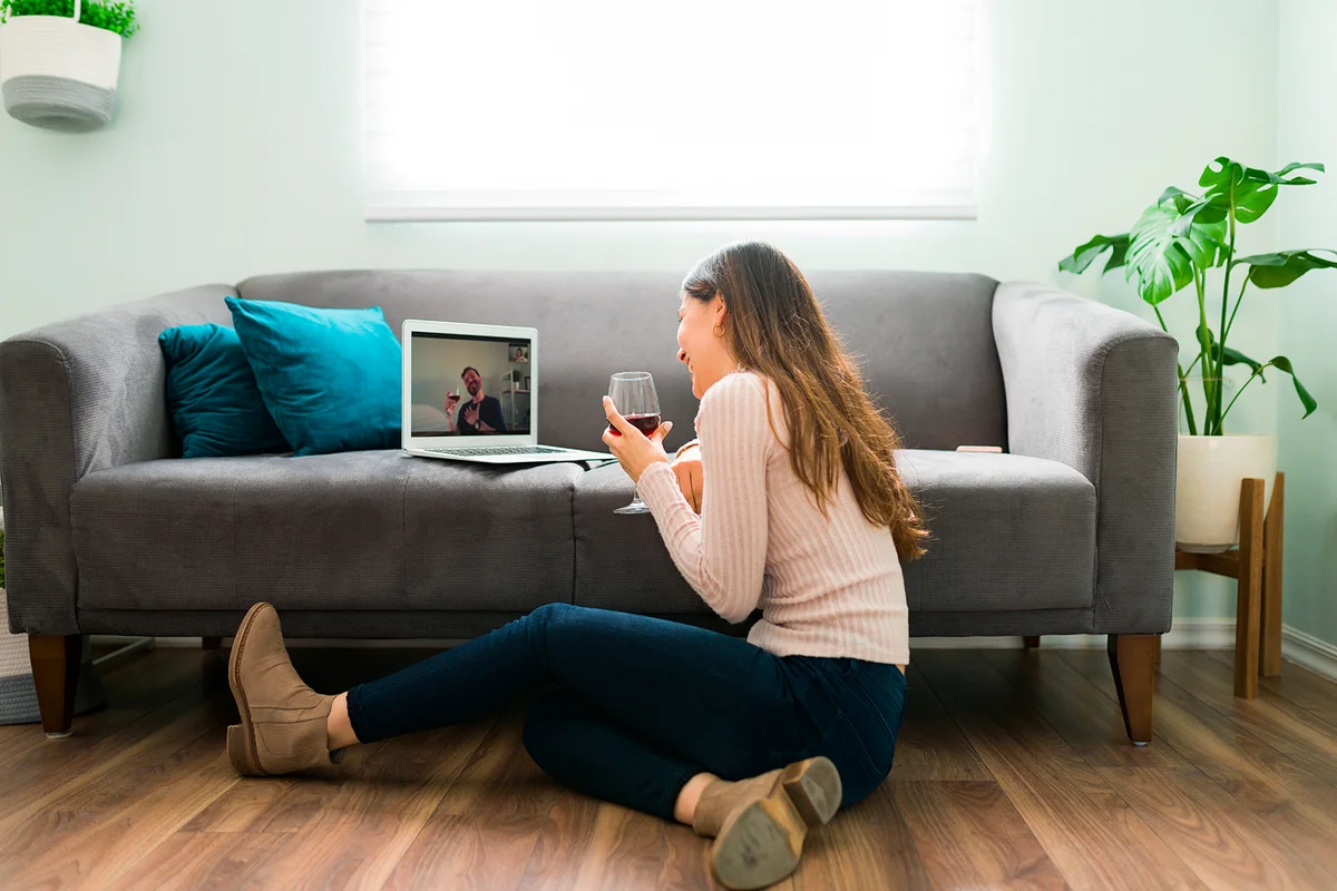 Good looking couple in a long-distance relationship is laughing and having a good time during a romatic online date