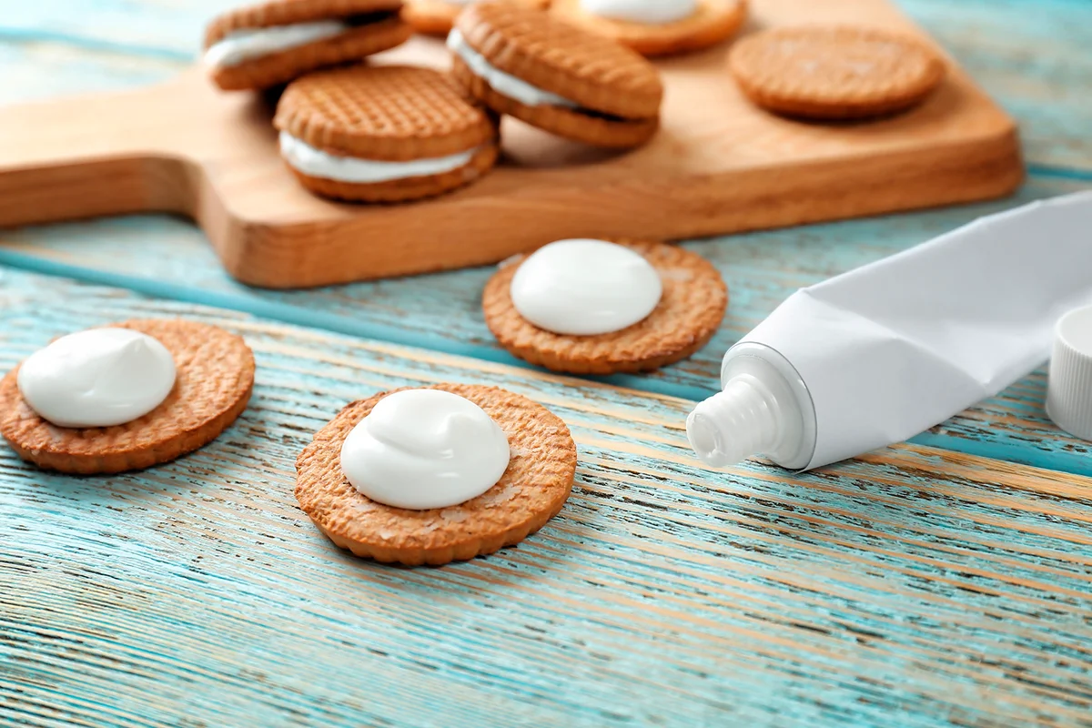 Cookies with toothpaste on table. April fools food