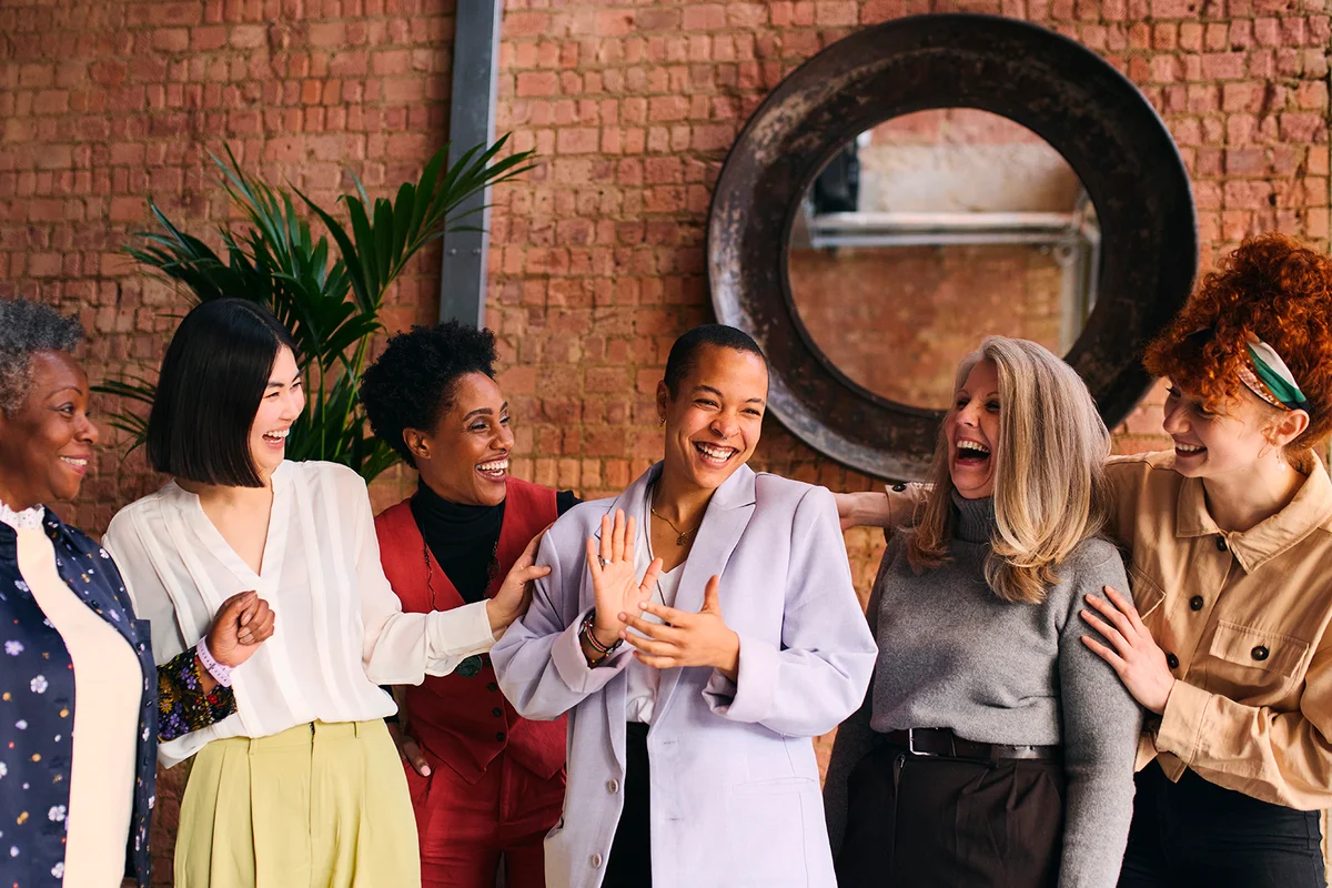 International Women's Day portrait of cheerful multiethnic mixed age range businesswomen celebrating, Embrace Equity
