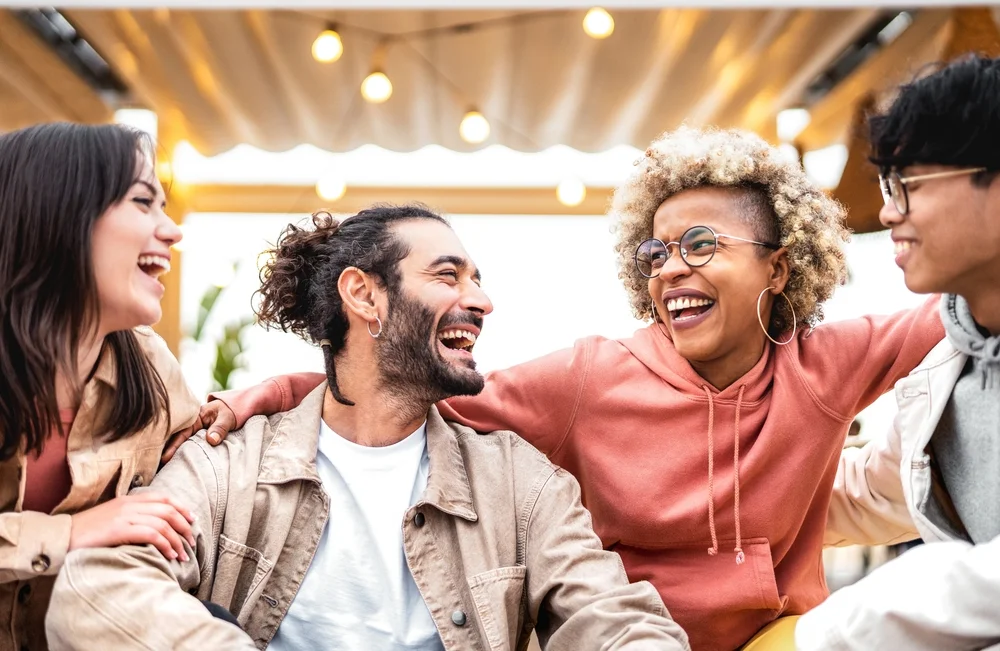 Multiracial young friends having fun at fancy venue location