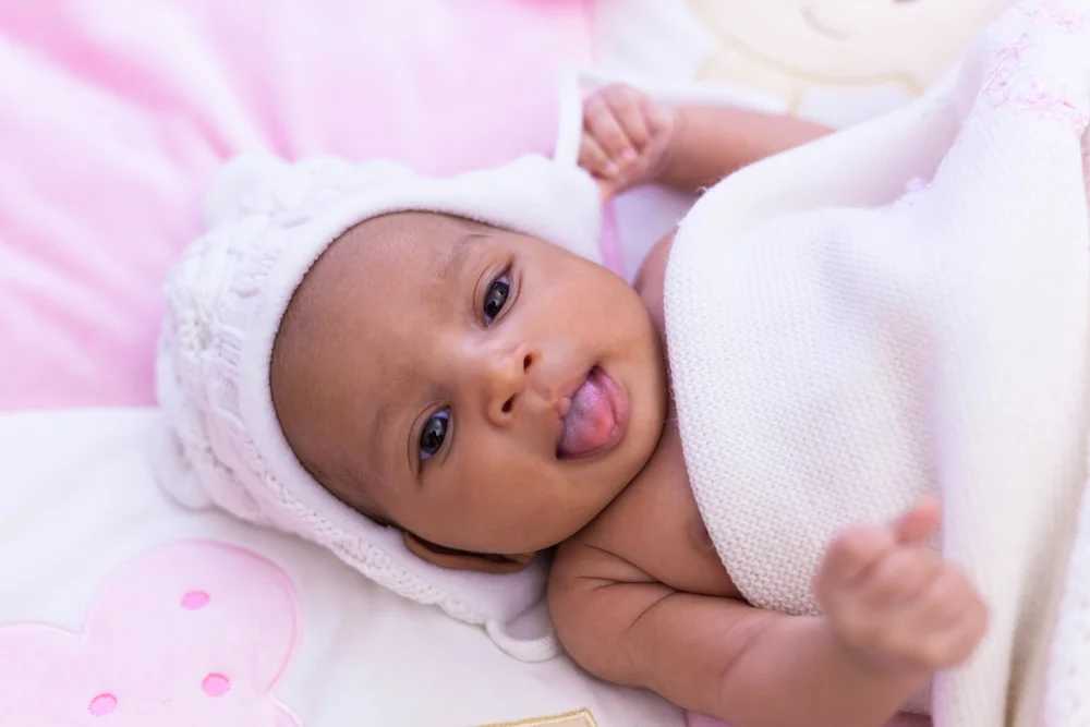 Adorable little African-american baby girl with her tongue out