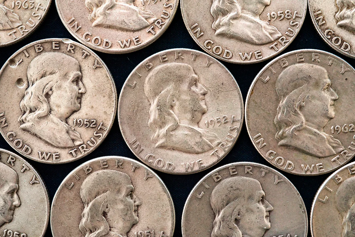 Rows of Franklin half dollars. (American coins)