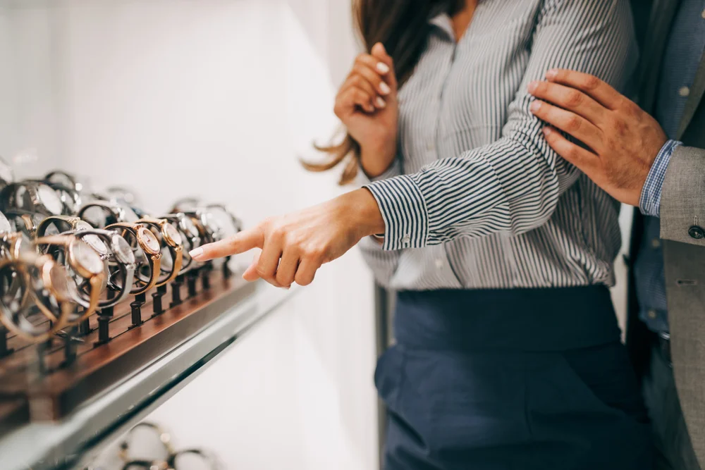 Elegant couple shopping for watches.