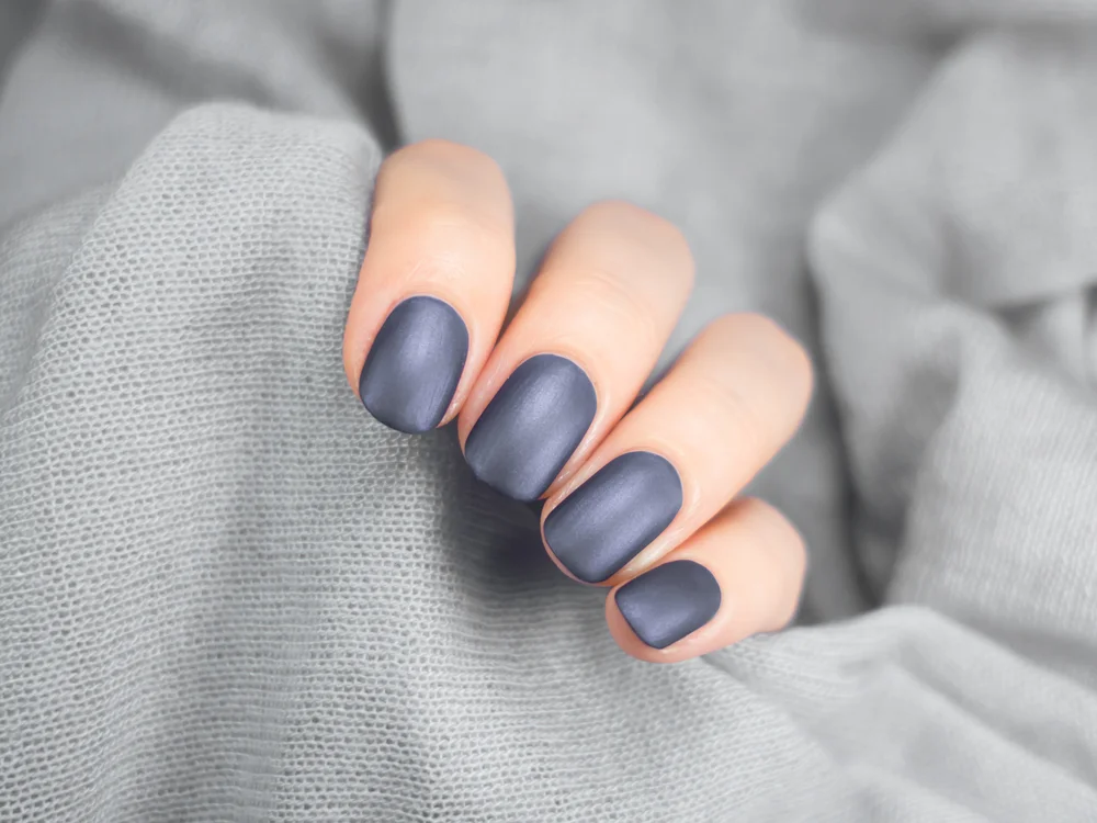 Beautiful grey manicure on hands