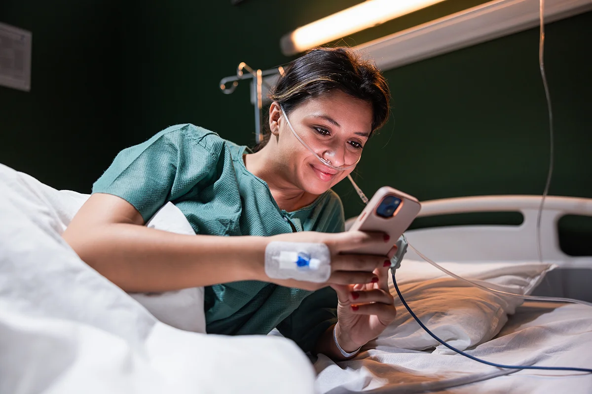 Young girl in the hospital using cellphone