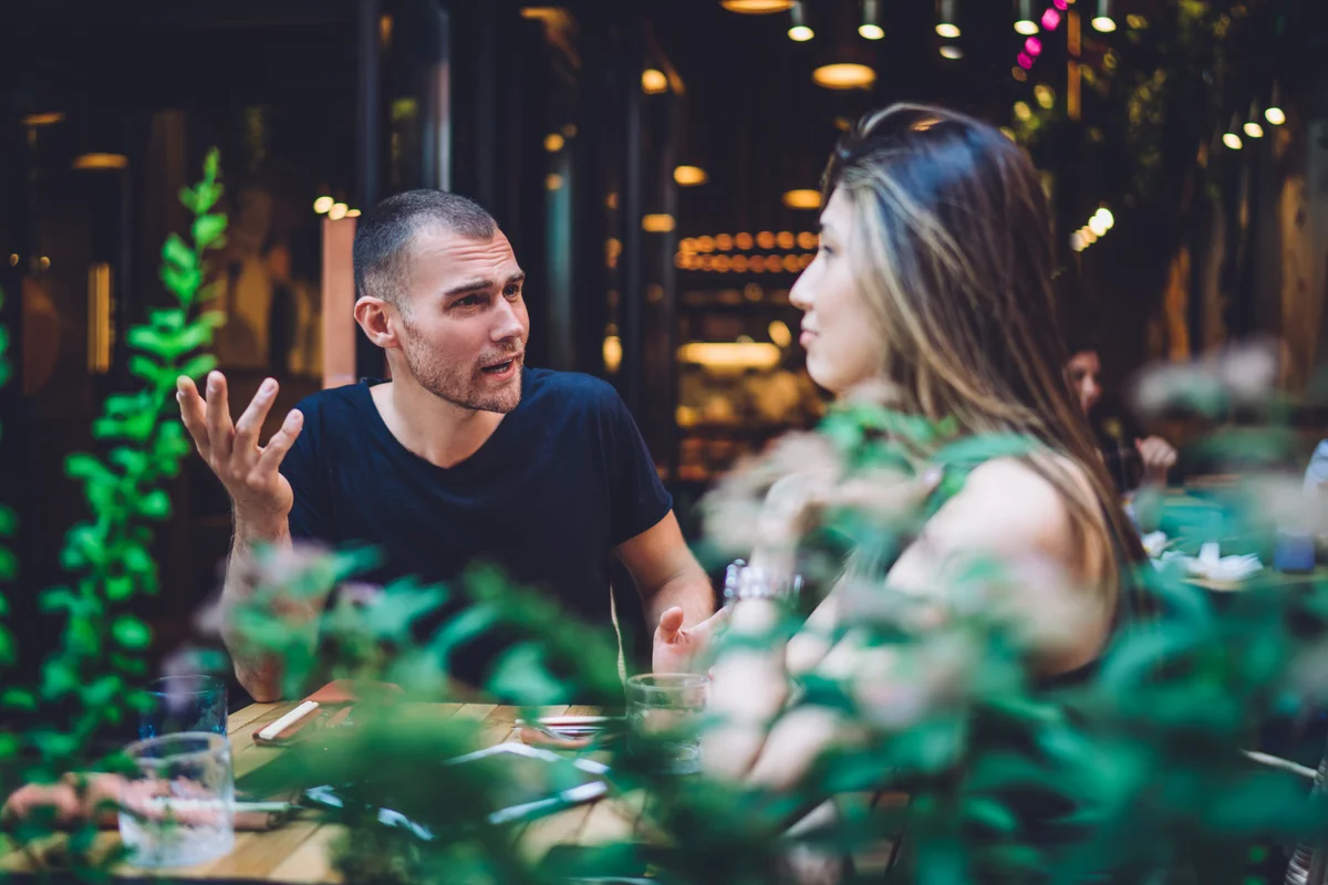couple talking on a restaurant patio