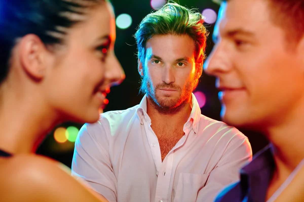 man looking at a couple jealously