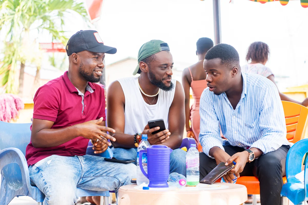 Three men having a conversation