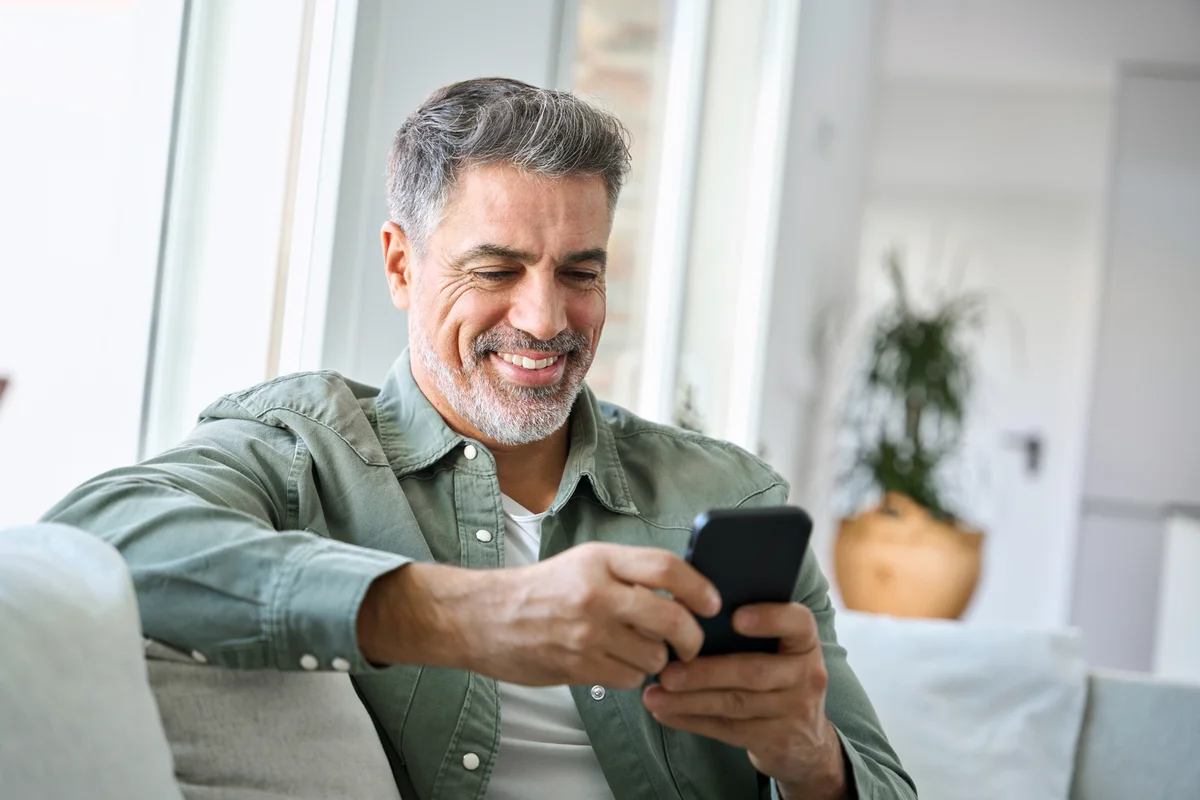 Man on his cellphone, smiling